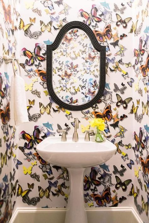 Clad in Christian Lacroix Butterfly Parade Wallpaper, this colorful contemporary powder room is fitted with a black beaded mirror mounted above a white pedestal sink finished with a satin nickel faucet. Christian Lacroix Wallpaper, Contemporary Powder Room, Half Bathroom Remodel, Framed Butterflies, Beaded Mirror, Aesthetic Bathroom, Design Hotel, Neutral Decor, Christian Lacroix