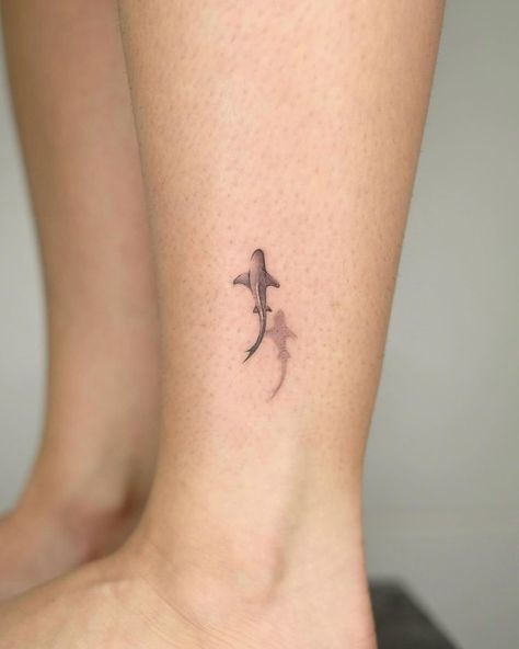 small shark tattoos • Instagram Shark Themed Tattoos, Small Shark Fin Tattoo, Shark Wrist Tattoo, Shark Small Tattoo, Bamboo Shark Tattoo, Swimming Shark Tattoo, Basking Shark Tattoo, Minimalist Shark Tattoo Simple, Tiny Shark Tattoo