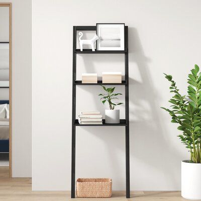 Tuck away titles or show off your favorite decorative pieces with this leaning ladder bookcase! It's crafted from a blend of solid and engineered wood with a black finish and features a streamlined, ladder-like design that leans against your walls for a modern look in any space. This piece features two slender shelves and one wider one, so it's great for both organization and display. Measuring 69' H x 23'' W x 19.69'' D overall, it's a call option that's ideal in narrow spaces. George Oliver | Leaning Ladder, Black Bookcase, Ladder Bookcase, Engineered Wood, Decorative Pieces, Brown And Grey, Bookcase, Black And Brown, Shelves