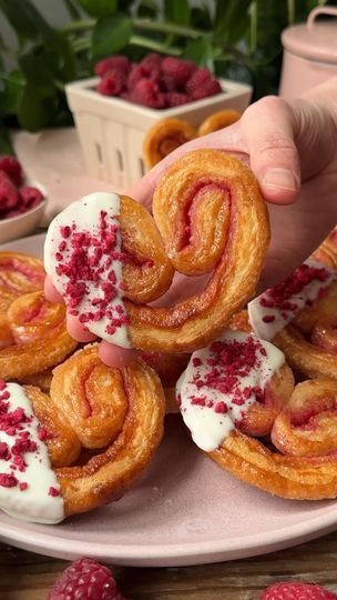 1M views · 2.2K reactions | White Chocolate Raspberry Palmiers | White Chocolate Raspberry Palmiers Recipe is in the comments. | By Crowded Kitchen | You only need three ingredients to make these raspberry palmier. They're one of our favorite easy treats made with puff pastry, sugar, and fleece-fried raspberries. It's totally optional to dip them in white chocolate but it's even more delicious. The key with this recipe is using high-quality puff pastry and making sure to chill the dough before baking so the butter doesn't leak out. It's also important to fold the dough correctly so that they form that beautiful heart shape in the oven. You can find the full recipe in the section below which includes all of our best tips and tricks. Raspberry Palmiers, Soup With Pesto, Palmiers Recipe, Pesto Grilled Cheese, Cheese Cracker Recipe, Grilled Cheese Croutons, Crowded Kitchen, Cheese Croutons, White Chocolate Recipes