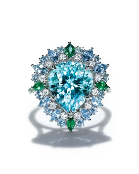 Tiffany ring set with a central 4.42ctt pear-shaped blue cuprian elbaite tourmaline surrounded by aquamarines, tsavorites and diamonds in platinum. From the 2015 Blue Book collection. Tiffany Rings, Blue Book, Tiffany Jewelry, Blue Books, Tiffany And Co, Bling Rings, Tiffany Blue, Blue Diamond, High Jewelry