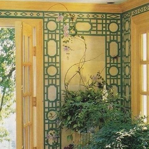 Deborah Rozanne Tenquist on Instagram: "AT HOME WITH OSCAR DE LA RENTA, Kent Connecticut, interior by French interior designer Vincent Fourcade. The sun or garden room with its pretty floral chintz sofa, rattan armchairs and chest with the  trompe-loeil trellis painted with climbing vines of clematis and wisteria has a timeless charm. Adding an abundance of potted plants and vases of flowers ensures an enduring appeal. Published in House and Garden USA which sadly no longer exists #oscardelarenta #vincentfourcade #interiordesign" Painted Trellis Ideas, Chintz Sofa, Bar Palladio, Kent Connecticut, Sofa Rattan, Floral Chintz, Bathroom Walls, Rattan Armchair, House And Garden