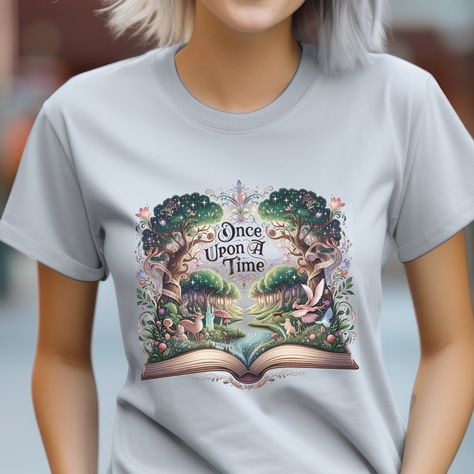 "Discover the Magic of Storytelling with Our Enchanted Forest Graphic Tee Unveil a World of Imagination Our Unisex Heavy Cotton Tee features a captivating design where a lush forest emerges from an open book, accompanied by the phrase \"Once Upon A Time\". This unique illustration symbolizes the endless possibilities hidden within stories, perfect for book lovers and nature enthusiasts alike. Comfort and Quality Combined Crafted from 100% US-grown cotton, this tee promises year-round comfort. The medium fabric weight (5.3 oz/yd² or 180 g/m²) strikes the perfect balance between durability and a lightweight feel. Its classic fit offers a relaxed and comfy experience, suitable for various body types. Designed for Everyone The tee's crew neckline and seamless sides contribute to its timeless l Shirts About Reading, Themed Letter Print T-shirt Gift, Themed Letter Print T-shirt For Gift, Themed Graphic Print T-shirt As Gift, Themed Graphic Print T-shirt For Gift, Themed Short Sleeve T-shirt For Gift, Graphic Print Crew Neck T-shirt For Reading, Literary Letter Print Crew Neck T-shirt, Literary Style T-shirt With Letter Print And Crew Neck