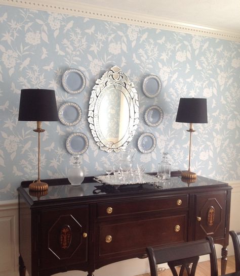 A pair of tall skinny buffet lamps are the perfect addition to the sideboard in this classic dining room