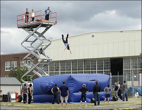 Inflatable stunt pads are used to allow stuntmen to jump from large heights and survive. They achieve this by using the principles of momentum and impulse. Then as he exerts a force on the pad the pad provides a small bit of resistance.Then over the next few seconds as the person keeps falling the pad slowly slows him down to a stop with its gradual resistance. By using the method to gradually slow him down the momentum of the stuntman gradually lessens over time which is what impulse is. Stunt Woman, Physics Projects, Mercer Island, My Bucket List, Downtown Los Angeles, Water Cooler, News Media, Unique Things, Movies Online