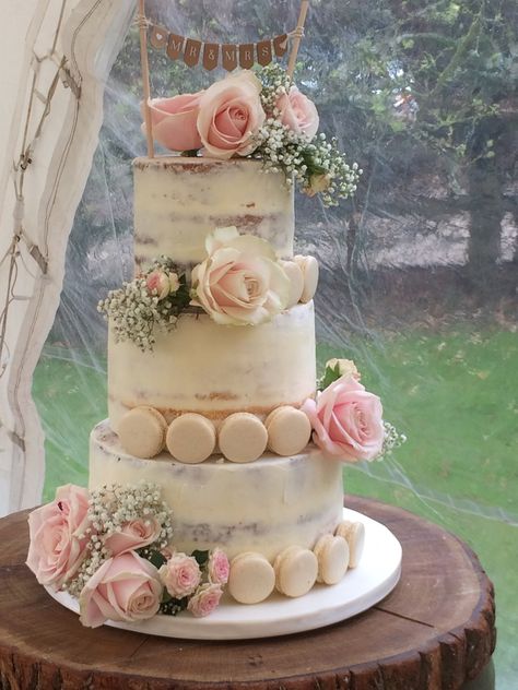 3 tier semi naked cake decorated with fresh blush pink roses and gypsophilia along with macarons and a bunting topper to go with the marquee and barn styling of this wedding. 25th Anniversary Cake 3 Tier, Wedding Cake Fall Flowers, Wedding Cake Pink Flowers, Wedding Cakes Lilac, Ideas Casamiento, Semi Naked Wedding Cake, Orchid Wedding Cake, 25 Anniversary Cake, Yellow Wedding Cake