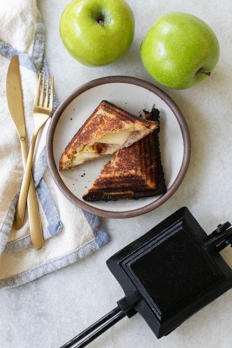 Apple mountain pies, also known as campfire pies or hobo pies, are buttery, sweet apple pies cooked over a campfire in a pie iron. They have a sweet homemade apple pie filling and a crispy, buttery crust. They are absolutely delicious! #mountianpies #campfirepies #hobopies #applepie #pie #dessert Campfire Apple Pie, Mountain Pie Recipes, Hobo Pies, Campfire Pies, Easy Apple Pie Filling, Mountain Pies, Pie Iron Recipes, Campfire Desserts, Apple Pie Recipe Easy