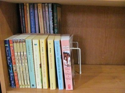 Use a wire shelf in deep bookshelves to create two rows of books and still be able to see what you have behind that first row. Book Shelves Organization Ideas, Book Shelf Organizer, Deep Book Shelf Organization, Dust Free Bookshelves, Deep Shelves Organization Bedroom, Stacking Bookshelf, Chapter Book Storage Ideas, Book Rotation Storage, How To Store Lots Of Books