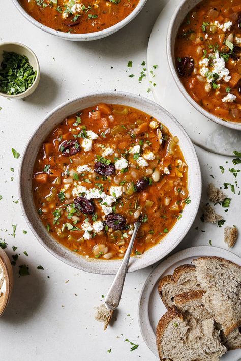 Fasolada, the iconic Greek White Bean Soup is a humble bean and vegetable soup, which is elevated with a bright acidic taste. The best part? It's served with Kalamata olives and feta cheese right on top. The result is a rich, hearty, perfectly balanced vegetarian soup that is on the table in just 45 minutes. Gluten-free. #wellseasonedstudio #fasolada #greeksoup #whitebeansoup #souprecipe Fasolada Soup Greece, Fasolada Soup, Greek White Bean Soup, Feta Soup, Bean And Vegetable Soup, How To Thicken Soup, Diced Carrots, Canned Beans, White Bean Soup