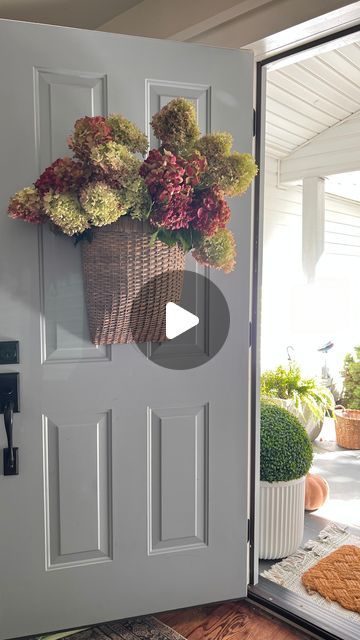 Life Stylishly - Home Decor on Instagram: "Comment ‘BASKET’ for the link to shop this look! 🧺🌸 

Switch things up this fall! 🍂 Instead of a traditional wreath, I used this beautiful basket and filled it with fall-drying hydrangeas for a unique front door look. 

It’s perfect for adding a cozy, seasonal touch without going the typical wreath route. Ready to create something different for your front door? 

The flowers are real but I’ve linked some great faux options and some smaller baskets that would give you a similar look." Door Basket Ideas, Drying Hydrangeas, Unique Front Door, Front Door Basket, Front Door Baskets, Unique Front Doors, Door Basket, Pink Hydrangeas, Traditional Wreath