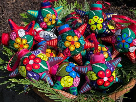 Traditional 5-Point Mexican Clay Piñata Christmas Ornaments, pre-strung with ribbon. Each Ornament is painted in a base color (nine options to choose from). They are then decorated with bright flowers, leaves, and other designs. Piñata Ornaments have 5-Points bursting from them. Ornaments are made of clay, but they are not heavy. Piñata Ornaments are medium/small in size -about 3 3/4" inches diameter from point to point. I ship orders on a DAILY basis via USPS Standard Shipping -rare exceptions Mexican Piñatas, Mexican Christmas Tree, Pinata Ornament, Christmas In Mexico, Mexican Christmas Decorations, Mexico Christmas, Mexican Gifts, Xmas Theme, Mexican Christmas