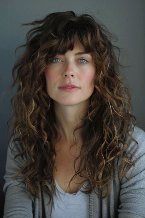 Bold Curly Hair Ideas You’ll Love Long Bangs Long Curly Hair, 2b Haircut Bangs, Loose Perm With Bangs, Naturally Wavy Bangs, Curly Hair Cuts With Bangs, Stevie Nicks Hair, Long Curly Hair With Bangs, Bangs Over 40, Long Layered Hair With Bangs