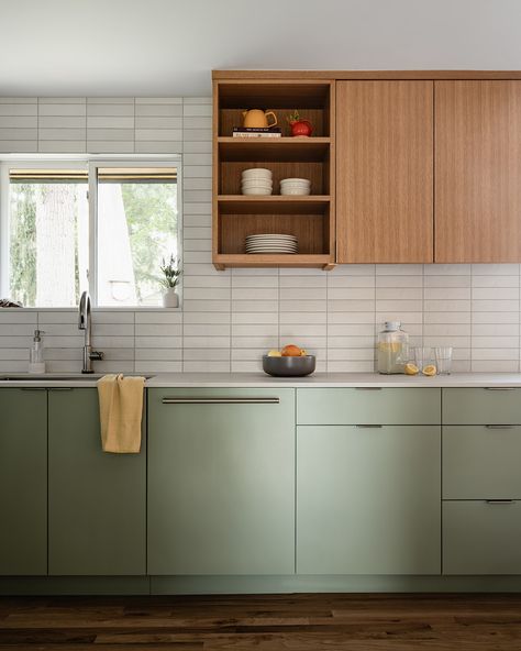 This kitchen features sleek, minimalistic cabinetry in a soft, pale green hue and a complimentary wood. The goal was to create a refreshing and contemporary ambiance while paying homage to the home's Mid-Century architecture. I think our talented team nailed it!⁠ 🙌🏻⁠
⁠
Check out The Home Code w/ Suzy Scott coming soon!⁠
⁠
#thehomecode #skinteriors #suzannekristineinteriors Pale Green And Wood Kitchen, Sage Green And Oak Kitchen, Green Oak Kitchen, Contemporary Green Kitchen, Sage Green And Wood Kitchen, Pale Green Kitchen, Mid Century Architecture, Oak Kitchen, Room Update