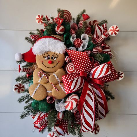 This extra large, beautiful Christmas wreath will be the topic of conversation with all your visitors.  Welcome all your family and friends with this whimsical Christmas holiday wreath. This wreath CANNOT fit between your storm door and regular door. I do try my best to use the highest quality of materials for outdoors, it is best to keep your wreath where it is protected from the elements.  Over time some colors and material will fade, but that is just due to the elements taking its effect on the wreath. Gingerbread Grapevine Wreath, Unique Christmas Wreaths For Front Door, Door Decorations Christmas, Christmas Mantles, Christmas Tree Train, Front Door Decorations, Diy Christmas Candy, Gingerbread Wreath, Christmas Peppermint