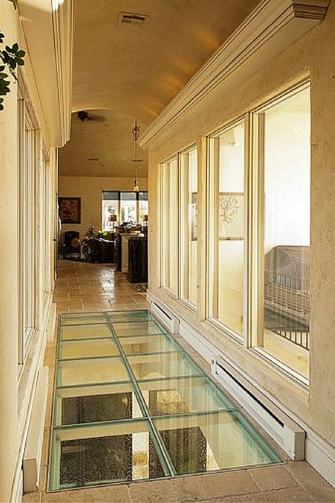 Glass floors and bridges are inspired ways to move light (and create a cool view) between floors. See how by clicking through. 30s House, Glass Flooring, Basement Hallway, Walking On Glass, Kitchen Basement, Glass Bridge, Glass Stairs, Glass Staircase, Laminated Glass