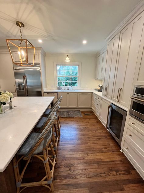 A string of additions and renovations had left the design for this 1940s carriage #house stuck in the 90s and in need of a full #remodel. Along with new electrical, plumbing and HVAC, the entire 3,500 square foot home received a fresh coat of paint and the hardwood floors were refinished. The wall between the #ktchen and breakfast nook was removed to create a larger, more functional space for entertaining. The new kitchen features a large center island finished in a rich brown to contrast wi... Kitchen Features, Functional Space, Carriage House, Breakfast Nook, The 90s, New Kitchen, Nook, Plumbing, Hardwood Floors