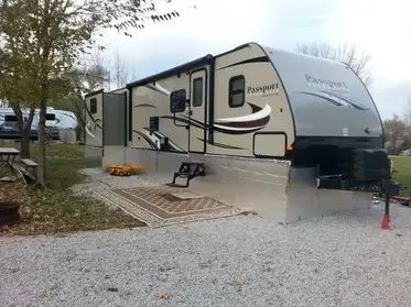 RV Skirting Ideas To Keep You and Your RV Protected - RV Expertise Camper Parking Pad Ideas At Home, Rv Skirting Ideas Diy, Rv Covers With Decks, Rv Painting Exterior, Rv Lot Landscaping Ideas, Rv Ceiling Ideas, Permanent Rv Site Ideas, Rv Shelter Ideas, Trailer Skirting Ideas