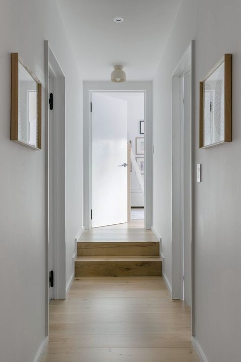 Now, a short hallway joins the two bedrooms and shared bathroom, which is through the door to the left. "It’s large enough to feel like the loft that it is, but also intimate in these back areas," says Watts. #dwell #beforeandafter #homerenovations Short Hallway, Loft Renovation, Bleached Walnut, Nyc Loft, Light Hardwood, Light Hardwood Floors, Midcentury Home, Entry Hallway, Modern Hallway