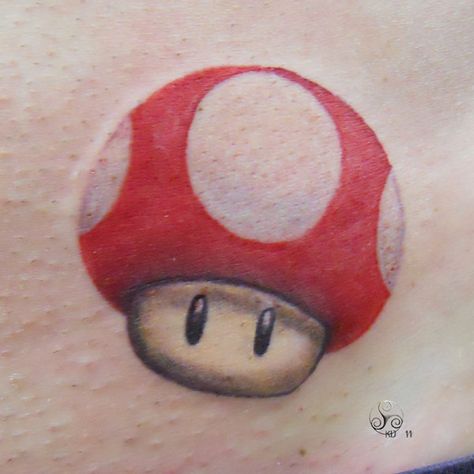 A cute tattoo of a recent design of the Mario magic mushroom « « Ratta Tattoo Mario Tattoo, Mushroom Tattoo, Gamer Tattoos, Mario Stuff, Sigil Tattoo, Insect Tattoo, Mushroom Tattoos, Gaming Tattoo, Magic Mushroom