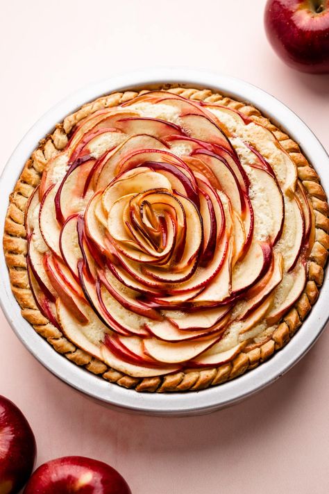 As pretty as it is delicious, this Almond Apple Rose Pie features thinly sliced apples arranged to look like a rose, on top of a layer of almond frangipane, which bakes beautifully in a flaky buttery crust. Rose Apple Pie, Apple Pie Roses, Apple Pie Rose, French Apple Almond Tart, Apple Pie Cinnamon Roll Roses, Apple Rose Pie, Apple Cider Vinegar Lemon, Apple Rose Tart, Types Of Desserts