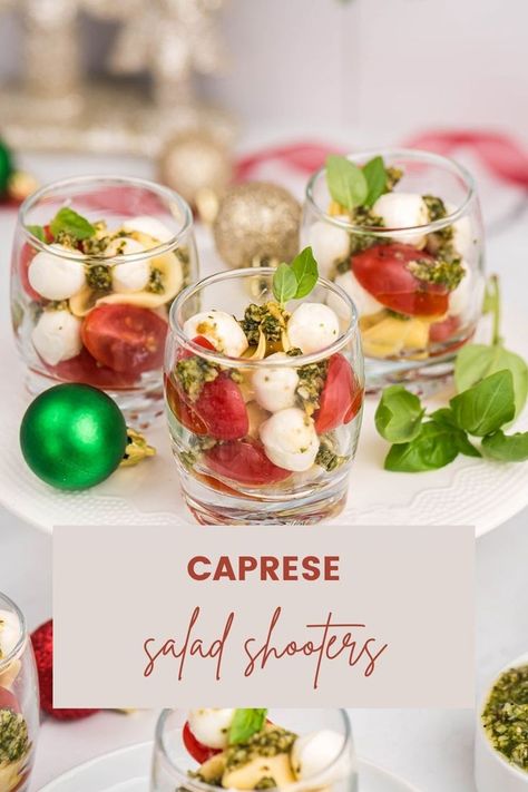 Make your holidays more fun with these Caprese Salad Shooters! The perfect side dish or appetizer for your next gathering, these bite-sized treats are sure to be a hit with family and friends! Packed with juicy tomatoes, fresh mozzarella, and a zesty balsamic glaze, these Caprese Salad Shooters are the perfect way to add a little extra fun to your holiday celebrations! #capresesaladshooters #sideorappetizer #holidaysnacks Caprese Salad In A Cup, Salad In A Cup Appetizer, Caprese Salad Skewers Appetizers, Caprese Salad Cups, Individual Caprese Salad Cups, Individual Salad Cups Party Ideas, Caprese Appetizer Bites, Shooter Appetizers, Mini Salads In A Cup