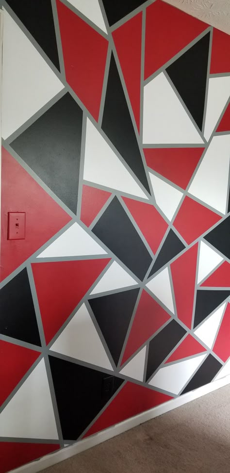 DIY geometric wall using red black and white paint on top of a gray base. Geometric Wall Paint Gray, Red Black White Gray Bedroom, Red Gray And Black Bedroom, White And Gray Accent Wall, Black And Red Walls Bedroom, Red Black And White House Decor, Red And Black Painted Walls Room Colors, Red And Grey Walls, Black And Red Accent Wall