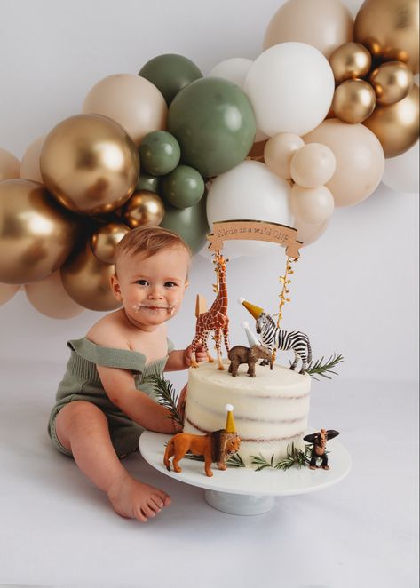 Alt=“baby boys first birthday cake smash eating cake of spoon wearing green romper”> Animal Cake 1st Birthday, 1st Birthday Photoshoot Wild One, Cake Smash Safari Theme, Safari One Year Old Birthday Photoshoot, Jungle Safari First Birthday, Neutral Jungle Birthday Party, Safari 1st Birthday Photoshoot, Natural Cake Smash, Wild One Cake Smash Photo Shoot