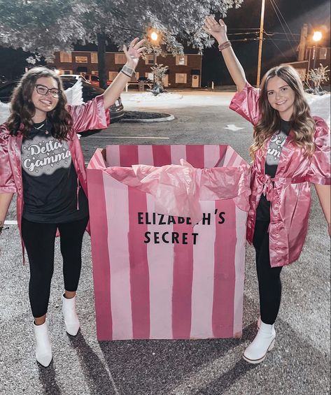 This is a picture of two girls in satin robes next to a large box painted like a Victoria secret box for a sorority event Big Little Box Reveal Ideas, Big Little Box Reveal, Sorority Row, Football Box, Sorority Photoshoot, Big Lil, Big Reveal, Sorority Big Little, Big Sis