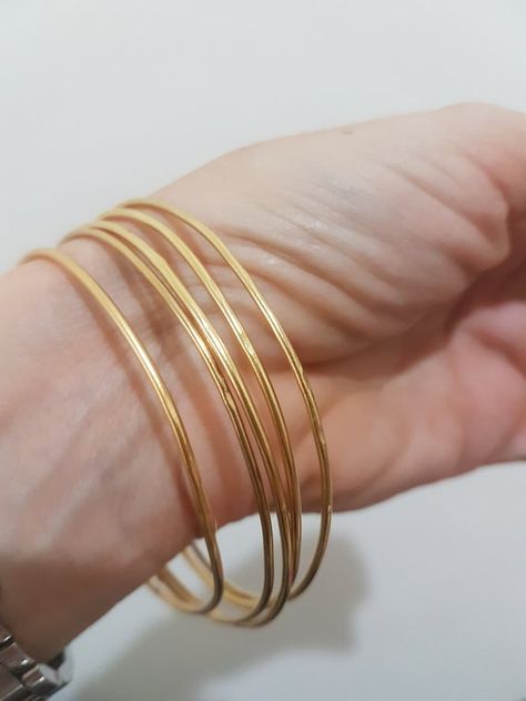 Gold bangle bracelet, made of a 1.5 mm gold plated wire, designed in a minimalist, simple chic. Available as a single gold bangle, set of 2 or 3, 4 or even 5 gold bangles these bracelets will make a beautiful addition for every look, day or night.  Dimensions: The bangle bracelet diameter is Single Gold Bangle, Gold Bangle Bracelet For Women, Simple Gold Bangle, 14k Gold Bangle Bracelet, Plain Gold Bangles, Solid Gold Bangle, Bangle Bracelet Gold, Gold Bracelet Simple, Gold Bangles For Women