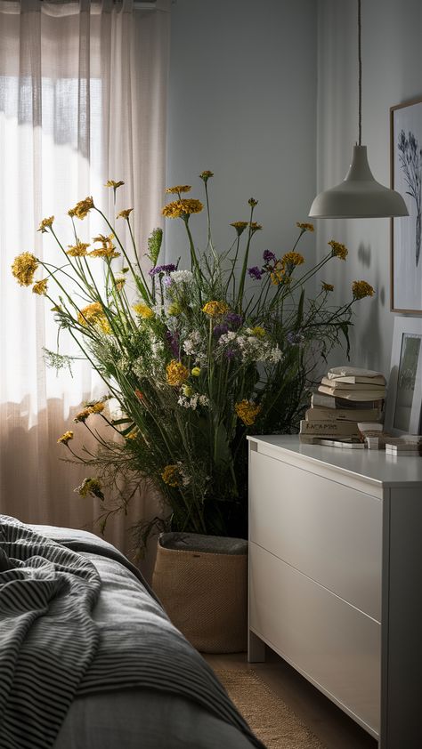 Revitalize your bedroom with a touch of nature and IKEA-inspired decor! This serene space features wildflowers elegantly placed on a MALM dresser, complemented by a stylish SKUBB storage box and a chic KNAPPA pendant lamp. The addition of a BERGPALM striped throw blanket adds a cozy personality, while gentle light filters through sheer curtains, creating a tranquil ambiance perfect for relaxation. Discover how to bring fresh vibes into your own space! Click for more inspiration! #BedroomInspo #IKEAStyle #WildflowerDecor Ikea Style, Wildflower Decor, Fresh Vibes, Malm Dresser, Striped Throw Blanket, Light Filters, Striped Throw, Light Filter, Sheer Curtains