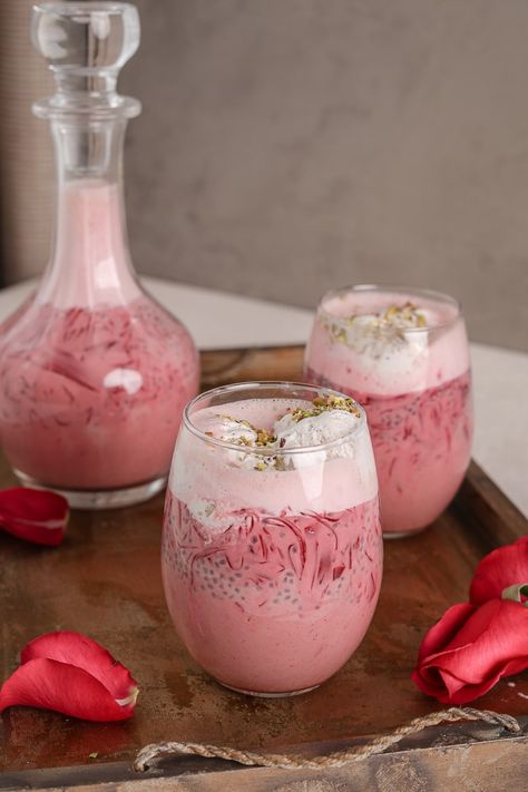 Homemade Vegan Falooda recipe is easy to pull off and healthy. Infused with the flavour of rose, this Indian drink, which can also be enjoyed as a dessert, is made with milk, strands of jelly, basil seeds and topped with coconut ice cream and crushed pistachios. Zero added sugar and naturally sweetened with dates. Crushed Pistachios, Falooda Recipe, Rose Drink, Milk Jelly, Indian Drinks, Frosting Recipes Easy, Recipes With Whipping Cream, Homemade Jelly, Rose Flavored