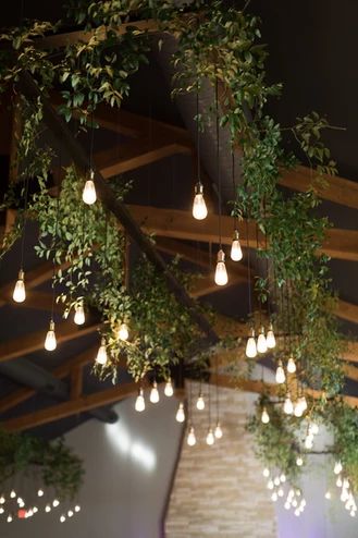 Hanging Faux Floral Arrangement, Greenery Ceiling, Ceiling Plants, Massage Room Decor, Hanging Greenery, Showroom Ideas, Skylight Window, Greenery Wedding Decor, Metal Beam