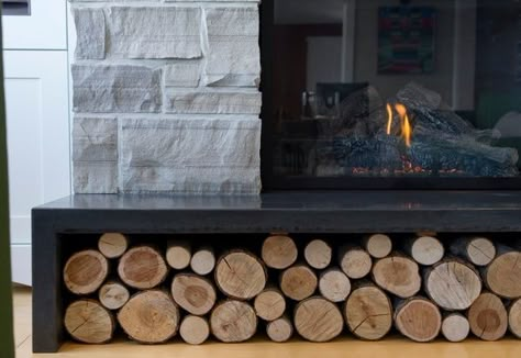 polished concrete hearth stone fireplace surround storage under hearth Fireplace Bench With Storage, Fireplace With Log Storage Built Ins, Wood Storage For Fireplace, Hearth With Wood Storage, Fireplace With Wood Storage Underneath, Bench Under Fireplace, Gas Fireplace Stone, Wood Storage Indoor, Fireplace Hearth Ideas