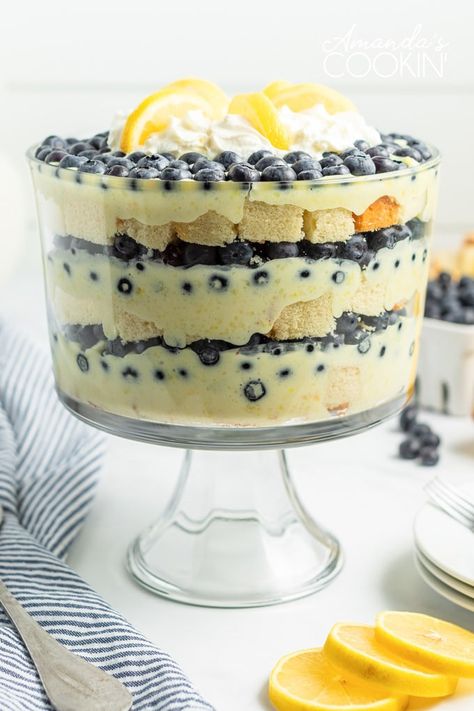 Juicy blueberries and bright lemon pudding combine in a stunning dessert. This mouthwatering lemon blueberry trifle is impressive yet incredibly easy! #blueberry #lemon #dessert #summerdessert #summer #potluck #trifle #lemontrifle #nobakedessert #puddingdessert #easter #easterdessert Blueberry Trifle Recipe, Lemon Blueberry Trifle, Lemon Trifle, Blueberry Trifle, Trifle Bowl Recipes, Pan Desserts, Tiramisu Trifle, Trifle Dessert Recipes, Cheesecake Trifle