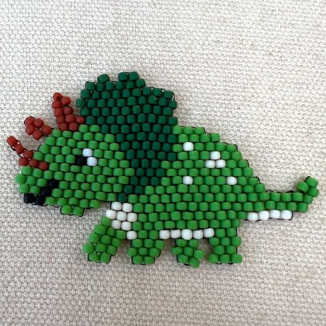 Triceratops dinosaur brick stitch pattern made with 11/0 Toho seed beads 🦖🪡🧵 Link in the bio 🔗🙂 #brickstitch #beadwork #handmade #triceratops #dinosaur #tohobeads #brickstitchpendant #beadmemes Brick Stitch Dinosaur, Beading Business, Toho Beads, Brick Stitch Pattern, Lizards, Brick Stitch, Seed Bead, Pattern Making, Business Ideas