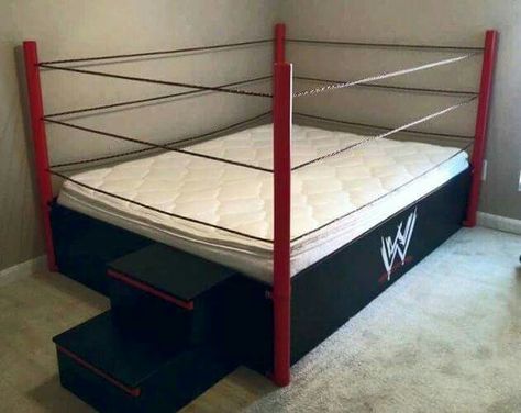 WWE WRESTLING RING BED. CUSTOM HOME-MADE Frame with Ring Steps and WWE LOGO on the side!  Looks to be a Full-Size Mattress.  Not produced by the WWE and likely one-of-a-kind.  Fun bed for kids! Wrestling Ring Bed, Wwe Bedroom, Kids' Bed, Boys Bedrooms, Put A Ring On It, Boy's Bedroom, Cool Beds, Kids' Room, Boy's Room