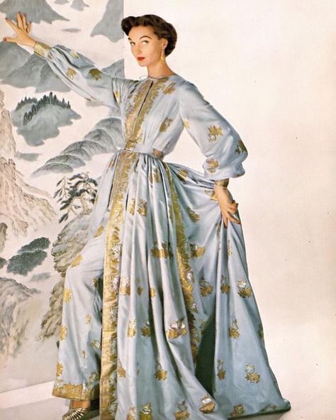 Evelyn Tripp wearing an at-home evening ensemble of pale blue gilded sari silk over narrow trousers designed by Traina-Norell, photo by Louise Dahl-Wolfe for Harper's Bazaar, October 1953. Gown With Pants, Vintage Loungewear, Tea Gown, Greek Myth, Halloween Pajamas, Fashion 1950s, Vintage Fashion Photography, Silk Gown, Sari Silk