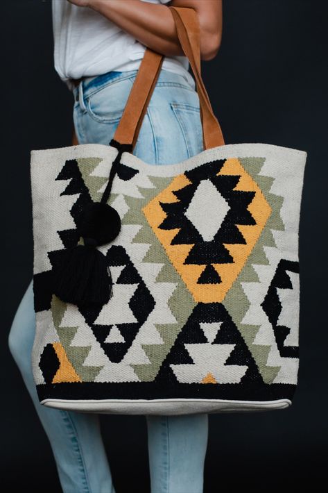 Our newest tote is a versatile and stylish bag, perfect for any spring occasion. With an Aztec inspired design, this tote features a pom tassel detail for added flair, and it makes the perfect weekender bag for all your essentials. Spring Tote, Knitted Hats Kids, Knit Hat For Men, Knit Jewelry, Kilim Bag, Summer Tote, Shoe Boutique, Knitting For Kids, Knitting Women