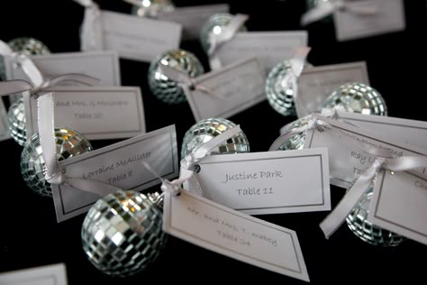 place cards attached to disco ball christmas ornaments Disco Ball Place Setting, Disco Place Cards, Disco Ball Place Card, Disco Ball Name Tag, Red Disco Ball, Party Disco Ball, Disco Ball Christmas, Christmas Ornament Ideas, Disco Birthday Party