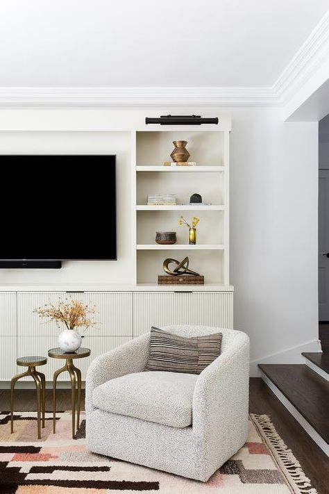 Chair Under Tv, Grey Jute Rug, Boucle Swivel Chair, Pale Pink Wallpaper, Light Gray Couch, Wall Mount Tv, Curved Couch, Fringe Rug, White Accent Table