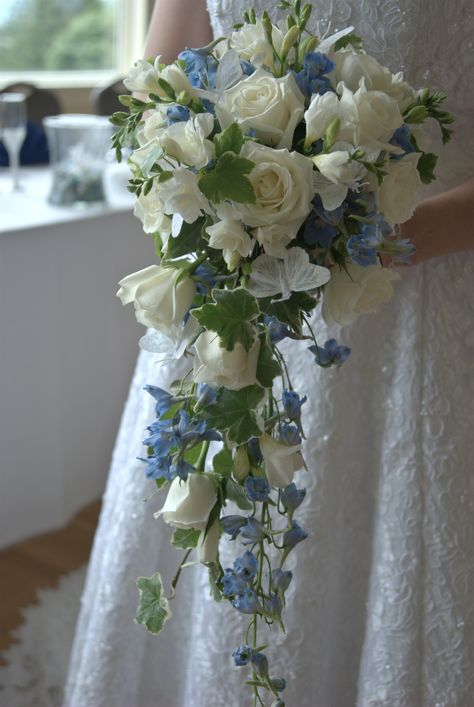 My bouquet: A cascading array of white roses, ivy, a mixture of different types of white and blue flowers, and white butterflies. Beach Wedding Decorations Reception, Elegant Wedding Flowers, Wedding Flower Guide, Cascading Wedding Bouquets, Blue Wedding Bouquet, Bridal Bouquet Flowers, Beautiful Wedding Flowers, White And Blue Flowers, Blue Wedding Flowers