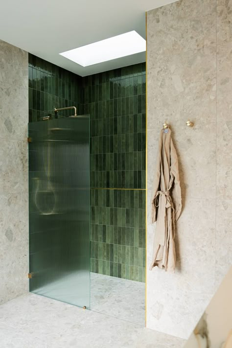 A glossy green feature tile, fluted glass shower screen and skylight above.   Sarah Carmel Design Studio offers both interior design and decorating services for Sydney homes and surrounds. Green Subway Tiles Bathroom, Same Tiles Floor And Wall Bathroom, Large Green Bathroom Tiles, Glass Shower Tiles, Glass Shower Design, Ribbed Shower Screen, Textured Wall Bathroom, Green Tiles Bathroom Interior Design, Shower With Skylight Above