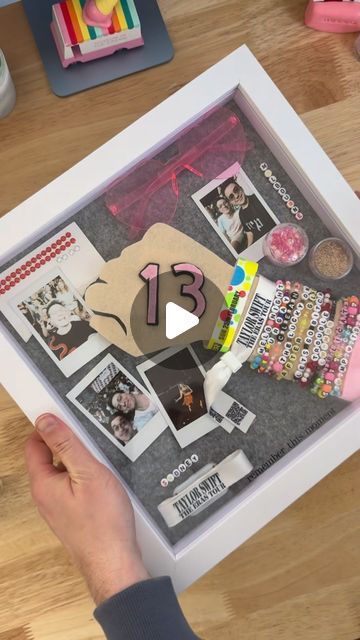 Mark Polchleb on Instagram: "Build my Eras Tour memory shadow box with me ✨   I didn’t put every single item into this, but kept it to key things that sum up my experience: from the creativity of making my oufits, to the special moments at each of my shows.   I also wanted to come up with a way to showcase the friendship bracelets so they could be seen and read.  #tstheerastour #sydneytstheerastour #melbournetstheerastour #erastourshadowbox #taylorswift #friendshipbracelets" Diy Shadow Box Ideas Memories, Eras Tour Memory Frame, Eras Tour Shadow Box Ideas, Eras Tour Memory, Box Frame Ideas, Memory Shadow Box, Memory Book Diy, Shadow Box Ideas, Photos Of Taylor Swift