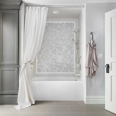 White and gray bathroom design features a floral mosaic marble shower tiled accent wall completed with a polished nickel shower kit. Shower Accent Tile, Marble Shower Tile, Grey Bathrooms Designs, Tile Accent Wall, Air Tub, Hydro Systems, Marble Showers, Small Remodel, Soaker Tub