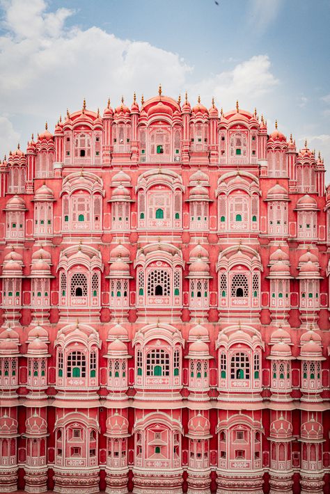 Painted pink in 1827, Rajasthan’s dreamy capital, Jaipur, rolls out like a vibrant tapestry onto pink streets. Here, you’ll find scenes straight out of a dream: camels pulling carts, women draped in colorful saris bustling by, and graceful white horses trotting through the thoroughfares. Against the backdrop of a dazzling blue sky, the iconic Hawa Mahal and City Palace add to the city’s dreamy allure, making Jaipur the embodiment of the India you’ve always imagined—a city of royalty. Jaipur Pink City, City Palace Jaipur, Hawa Mahal, Pink Street, Pink City, White Horses, Rajasthan India, Jaipur India, Jaipur