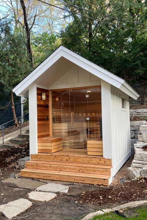 This sauna build features clear western red cedar walls, benching, bench skirts, and backrest.  We built the floor with cedar deckboards.  It has strip lighting on the backrest, a ceiling light and two lights outside of the sauna.  It features a Finnleo Himalaya Rock Tower Heater and a SaunaLogic 2.0 Smart Control. Outdoor Sauna With Changing Room, Wood Fired Saunas, In Bathroom Sauna, Shed To Sauna, Hot Tub Building, Sauna With Salt Wall, Build Sauna Outdoor, Barrel Sauna Roof, Outdoor Barrel Sauna Landscaping