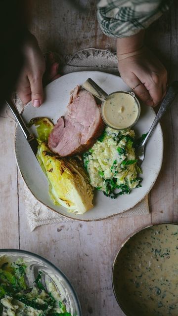 Annie Mae Herring on Instagram: "I grew up eating this meal in its purest form. Boiled gammon, cabbage and mash potato. I wanted to elevate this recipe by adding more flavour through the dish....aka butter is heavily involved. ✨

Ingredients 💚
(Gammon)🧡
2 kG Smoked Gammon 
(For the glaze)
70ml Honey or Maple Syrup 
1 heaped TBSP Mustard
2 Tbsp Dark Brown Sugar 
1 Pinch Salt

(Colcannon)💚
1KG Potatoes, peeled, quartered and boiled in salted water until fork tender (around 18 minutes)
140g Savoy Cabbage, finely sliced and steamed or boiled until tender 
100g Smoked Bacon Lardons, fried until golden brown
150ml Double Cream 
100g Salted Butter 
Salt and Black Pepper 

(Sweetheart Cabbage) 💚
1 Large Sweetheart Cabbage, halved and washed carefully 

70g Melted Salted Butter 
1 Tsp finely ch Annie Mae, Mash Potato, Dark Brown Sugar, Savoy Cabbage, Double Cream, Smoked Bacon, Salted Butter, Golden Brown, Maple Syrup