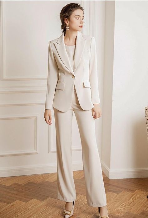 Experience luxury and sophistication in our Three Pcs Beige Pantsuit Set, featuring a beautiful silk blouse and pants made of the finest quality silk. Elevate your wardrobe with this exclusive set, perfect for any occasion. Three Pcs Beige Pantsuit Set Description: Peak lapels; front button blazer V-neck, Long sleeves; button cuffs. Structured shoulders. Chest welt pockets. Hip flap pockets Polyester 100% Silk blouse Wide leg loose fit pants Imported Brand - Aision Model Number - 22CPB82 Washing Beige Suit Outfit Women, Beige Suits Women, Beige Pantsuit, Online Shopping Clothes Women, Blouse And Pants, Cream Suit, Simple Casual Outfits, Beige Suits, Professional Outfits Women