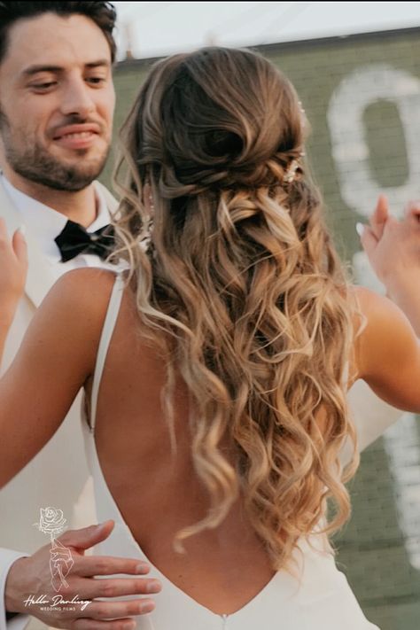 Bride has nice hairstyle for wedding day as she dances with groom