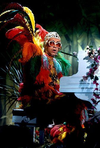 Photos: Elton John’s Outfits Through the Years – Rolling Stone Elton John Costume, Electric Ladyland, John Barry, Captain Fantastic, A Night At The Opera, Dark Wave, Rocket Man, Chest Hair, The Muppet Show